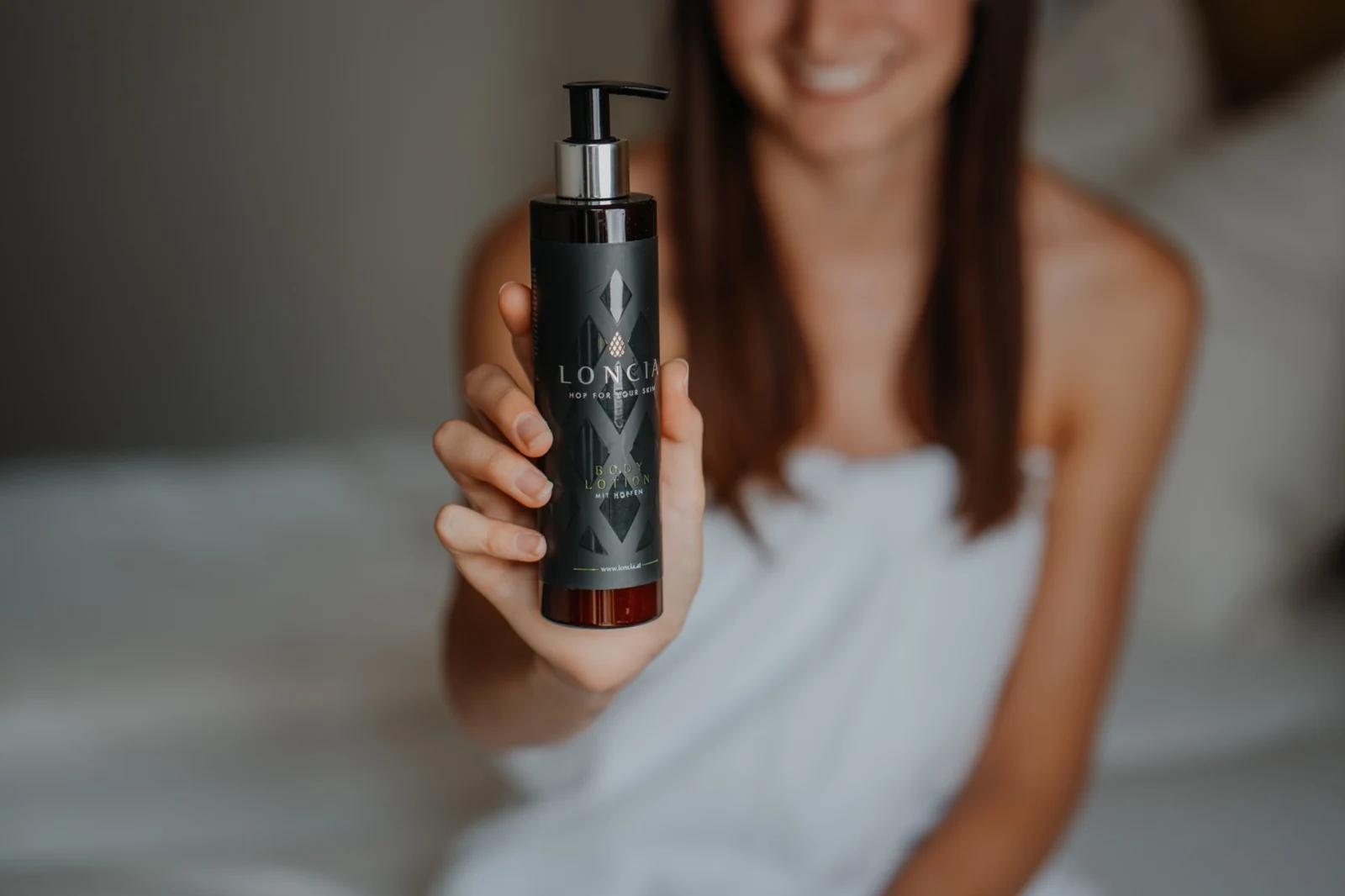 Eine Frau präsentiert die LONCIA Body Lotion